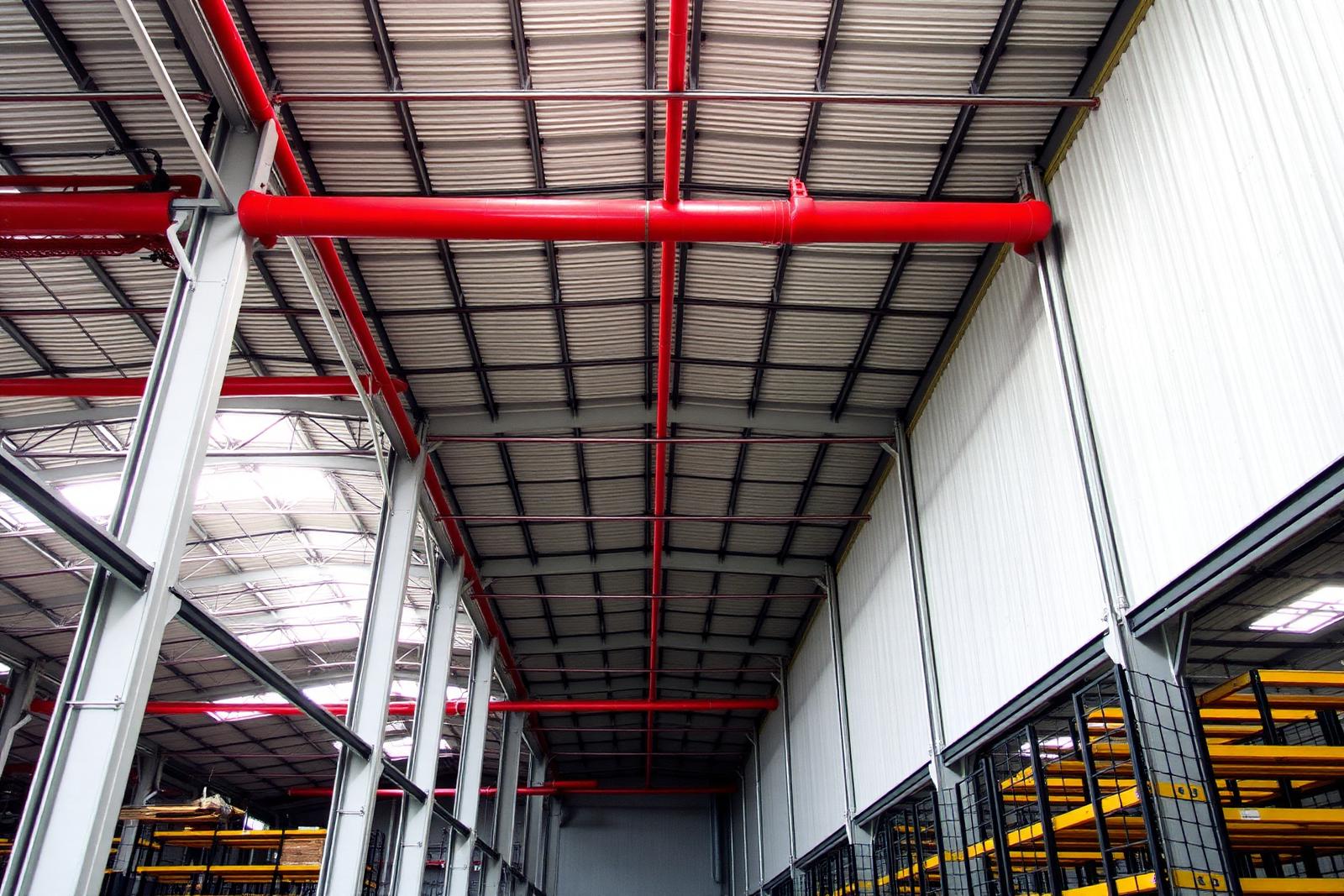Fire protection pipework and detection installed across an industrial warehouse